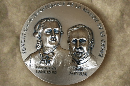 A round bronze disc with two faces on it