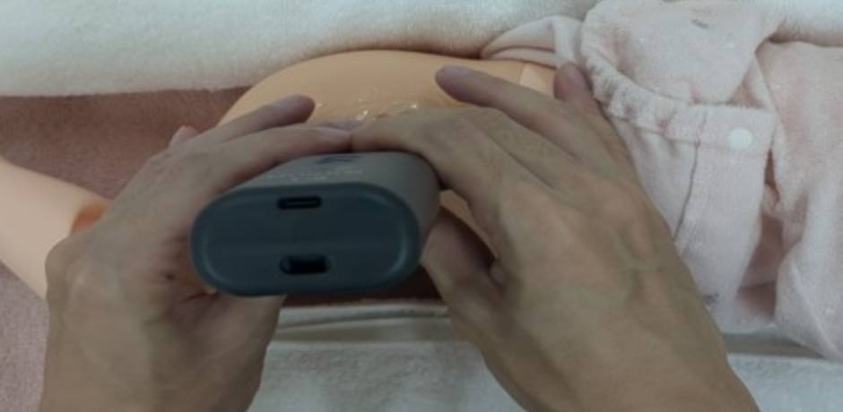 Close up of ultrasound being used on a practice dummy.